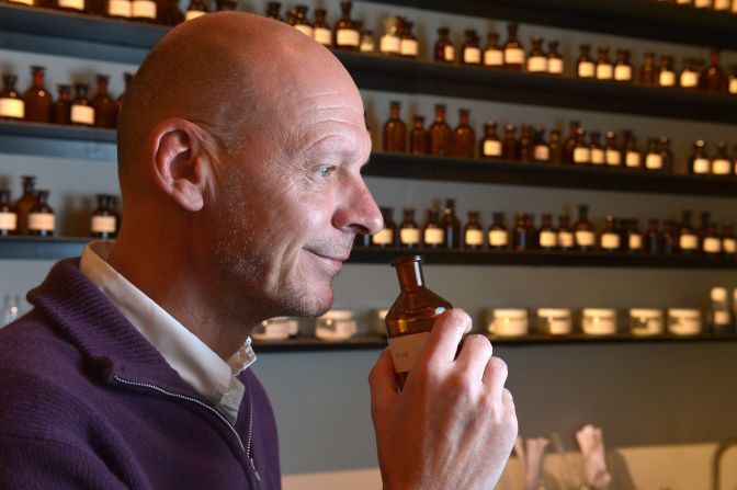 British perfumer Mark Buxton smells one of his creations at his workplace in Paris.