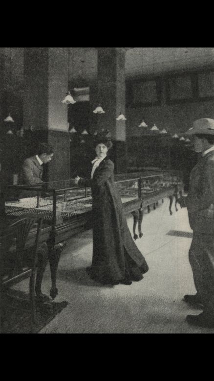 This photo illustration, showing a woman and two men in a jewelry store, was for an article in 1902. Ben-Yusuf, the London-born daughter of a German mother and Algerian father, came to the United States in 1895. Later in life, she transitioned from photography into the world of fashion. 