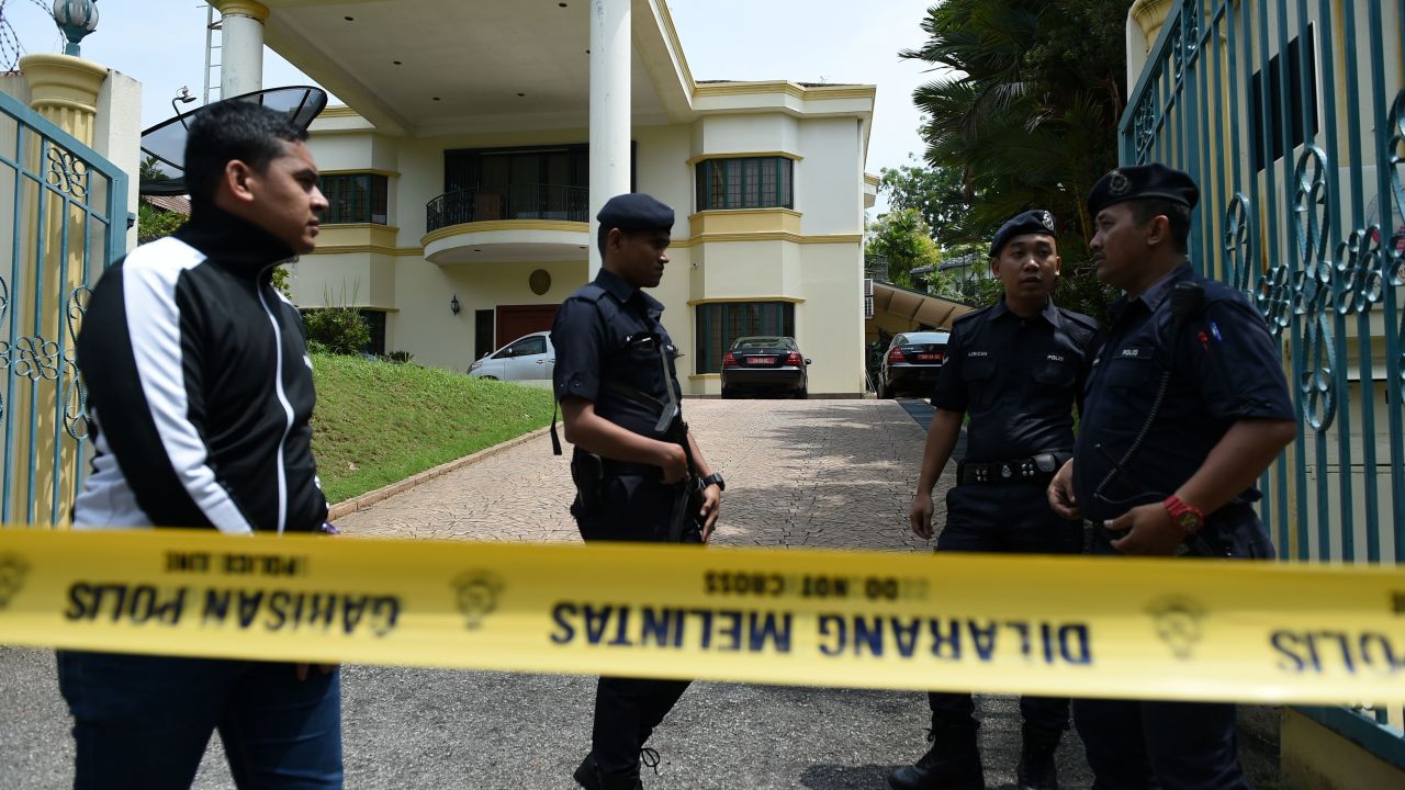 Police personnel keep watch behind a police line drawn across the entrance to the North Korean embassy in Kuala Lumpur on March 7, 2017.