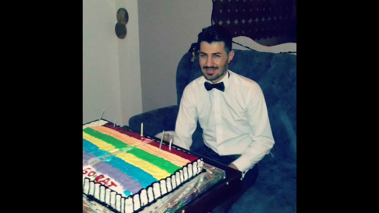 Zigorat on his birthday with a rainbow flag cake.