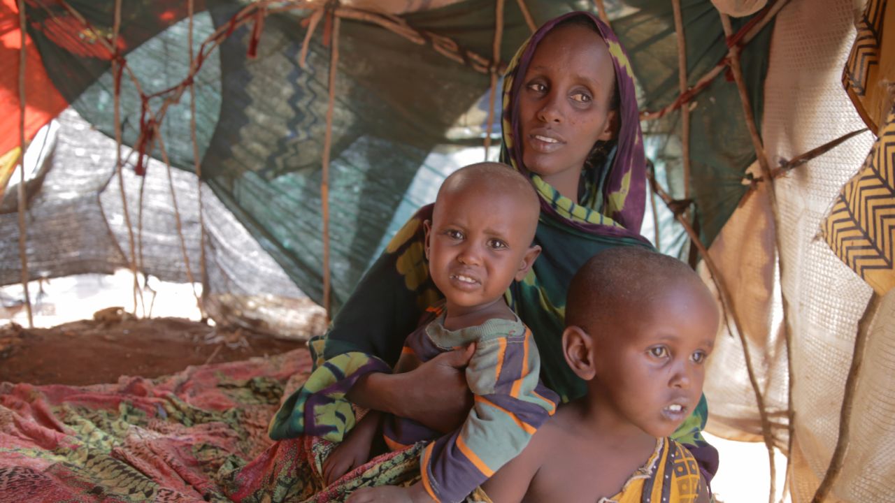 Fatuma Hassan Hussein sits with her two children Shankaron, 3, and Rahma, 15 months, in a makeshift shelter in Baidoa, Somalia. Fatuma says the family hasn?t eaten properly in 10 days. She says she travelled more than a hundred miles to get to a camp in Baidoa, Somalia.