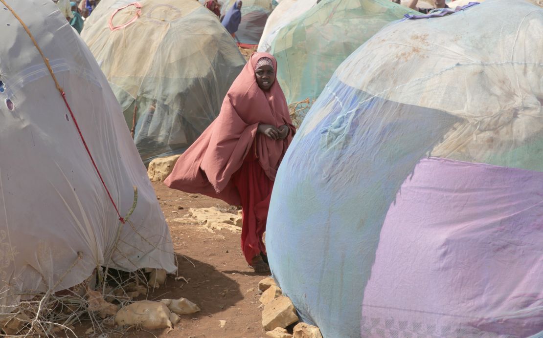 A young girl stands in front of makeshift shelters in Baidoa. More than 6 million people need food assistance in Somalia. 
