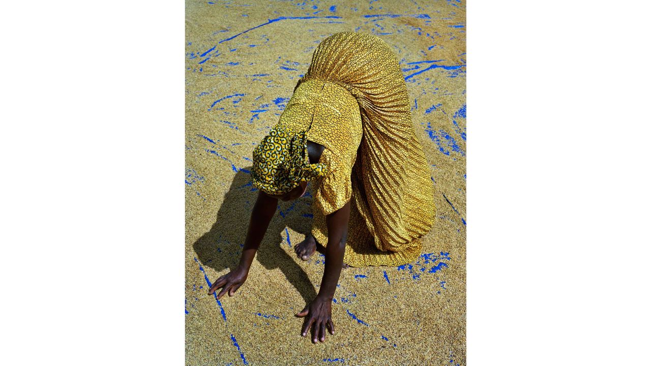 Sanwougou Lalle, 38, drying rice in the village of Tonte, Togo