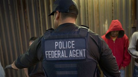An ICE agent in San Diego directs a group of men being deported to Mexico in February 2015. 