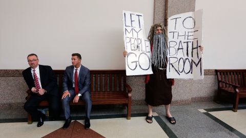 John Erler protests as a state Senate committee hears testimony on the bill.