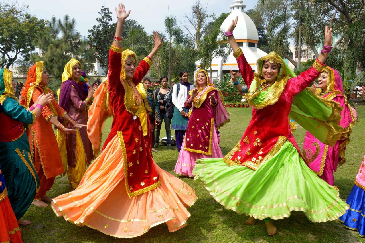 Women wear traditional Punjabi dresses as they dance during an event in Amritsar, India.