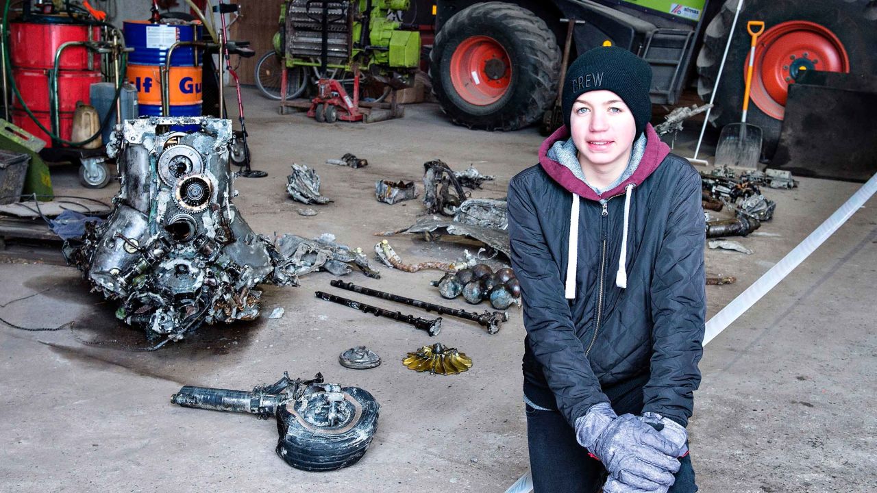 14-year-old Danish boy Daniel Rom Kristensen is photographed on March 7, 2017 in front of debris from the wreck of a World War II aircraft, which Daniel and his father Klaus Kristensen found yesterday near Birkelse by Aabybro, in Northern Jutland.  
In the wreck there was also the body of the plane's pilot and some ammunition. The plane is a German fighter plane type ME 109 Messerschmidt from World War II. Daniel and Klaus Kristensen found the wreck with a metal dectector in a bog.  / AFP PHOTO / Scanpix Denmark / Henning Bagger / Denmark OUT        (Photo credit should read HENNING BAGGER/AFP/Getty Images)