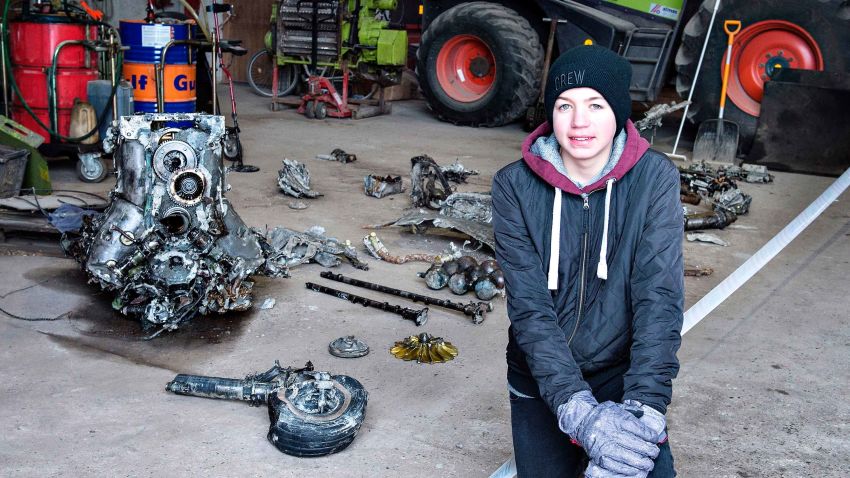 14-year-old Danish boy Daniel Rom Kristensen is photographed on March 7, 2017 in front of debris from the wreck of a World War II aircraft, which Daniel and his father Klaus Kristensen found yesterday near Birkelse by Aabybro, in Northern Jutland.  In the wreck there was also the body of the plane's pilot and some ammunition. The plane is a German fighter plane type ME 109 Messerschmidt from World War II. Daniel and Klaus Kristensen found the wreck with a metal dectector in a bog.  / AFP PHOTO / Scanpix Denmark / Henning Bagger / Denmark OUT        (Photo credit should read HENNING BAGGER/AFP/Getty Images)