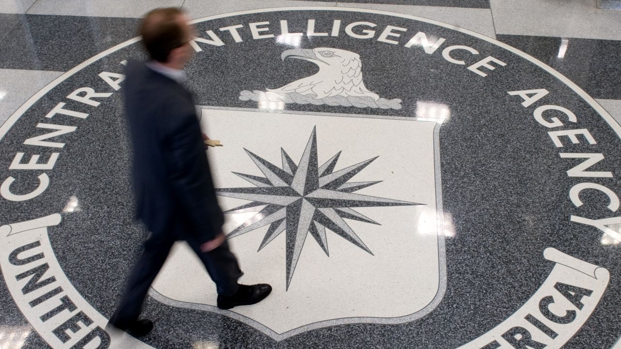 A man crosses the Central Intelligence Agency (CIA) logo in the lobby of CIA Headquarters in Langley, Virginia, on August 14, 2008. 