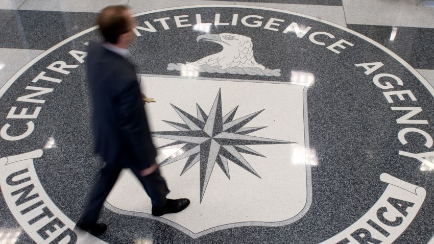 A man crosses the Central Intelligence Agency (CIA) logo in the lobby of CIA Headquarters in Langley, Virginia, on August 14, 2008.