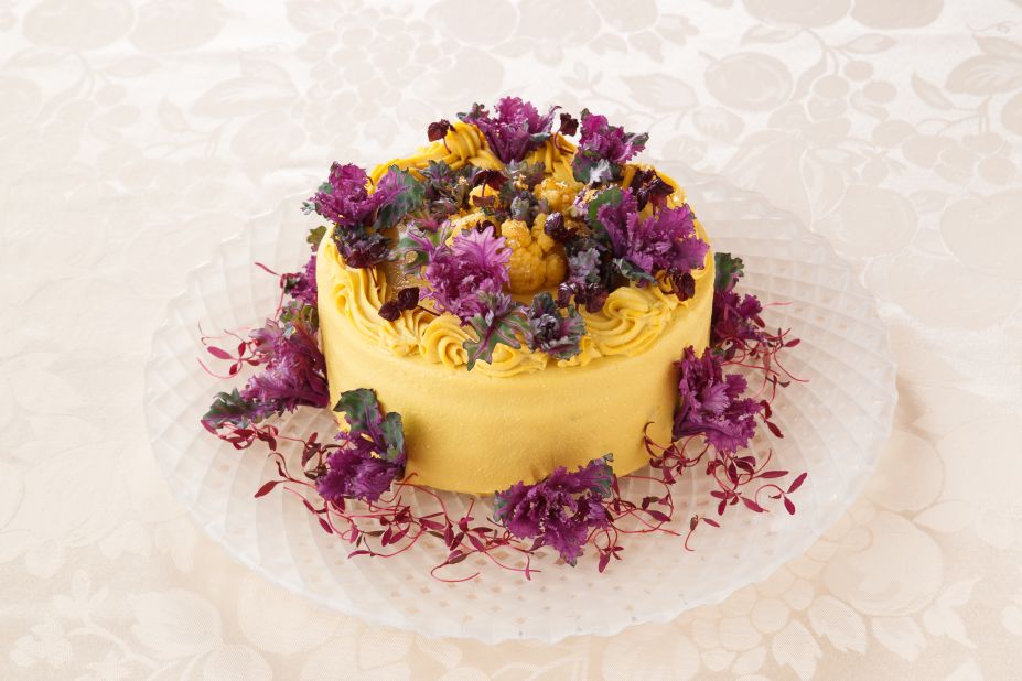 This next-level cake, flavored with pumpkin, has broccoli, cauliflower, beets and purple sweet potato inside, wrapped in yellow cauliflower, purple petit veil and amaranth sprouts.