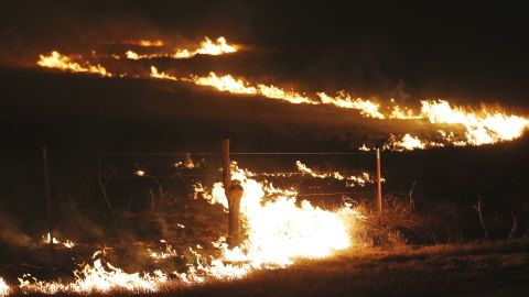 Wildfires swept by high winds burn near Protection, Kansas, on Tuesday.