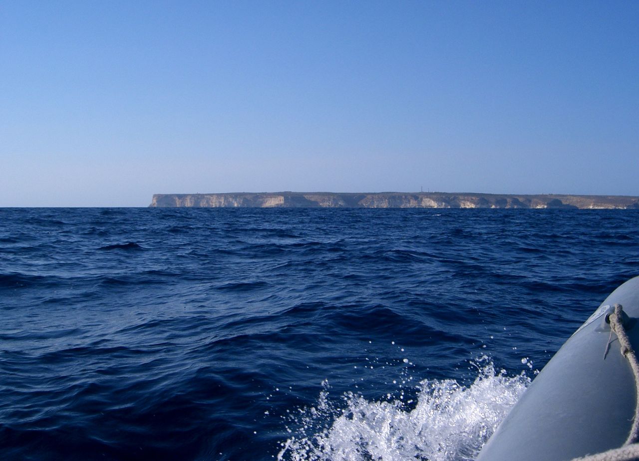 Lampedusa Island -- blinding white cliffs, fluorescent blue waters, African-like temperatures and dry desert.