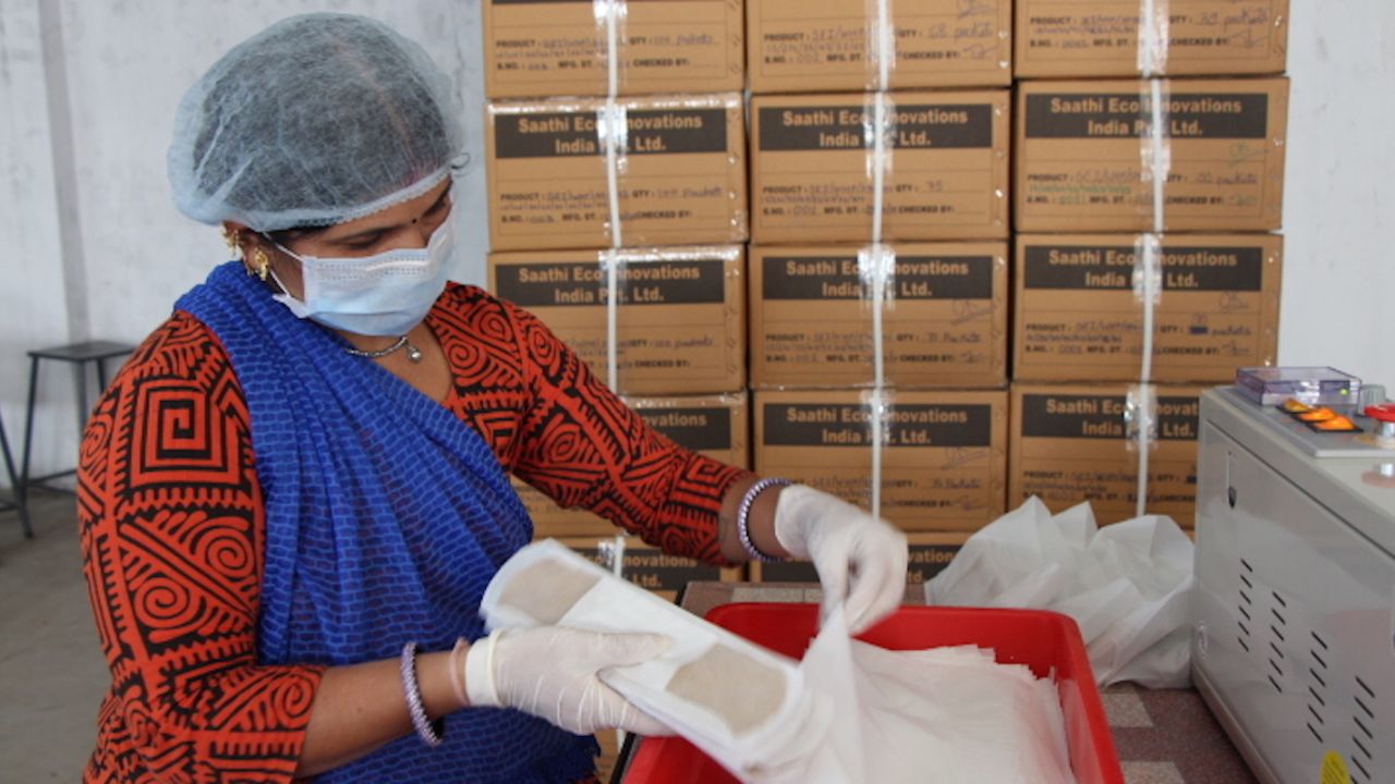 A worker loads boxes with Saathi banana fiber sanitary pads. Saathi produces about 1,300 pads a day.