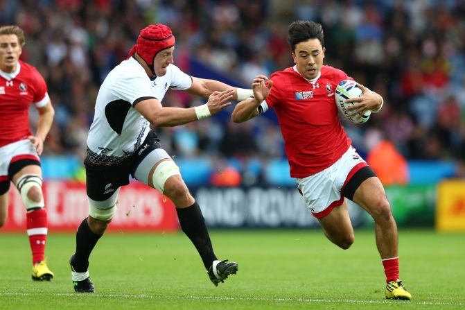 Hirayama evades Mihai Macovei of Romania during Canada's 17-15 defeat at the 2015 Rugby World Cup.