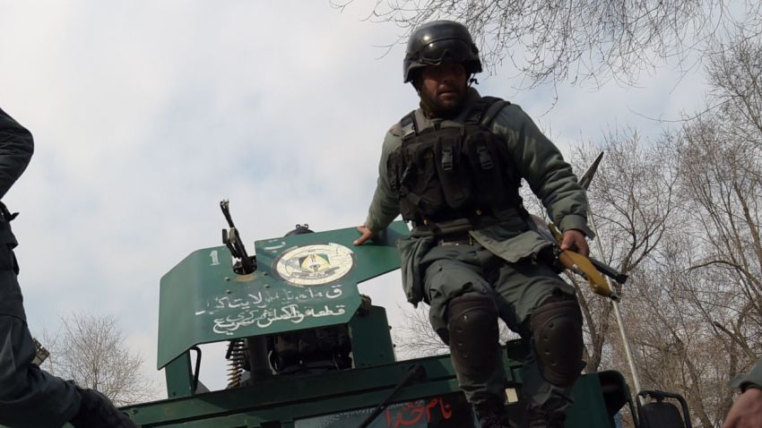 TOPSHOT - Afghan policemen leap from a vehicle as they arrive at the site of an explosion in Kabul on March 8, 2017. 
An explosion and gunfire rattled Kabul's diplomatic district, as insurgents attacked Afghanistan's largest military hospital, officials said.  / AFP PHOTO / SHAH MARAI        (Photo credit should read SHAH MARAI/AFP/Getty Images)