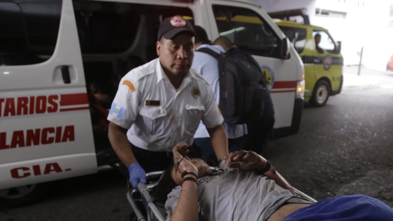 A victim of the fire at the San Jose Pinula youth home is rushed to a hospital Wednesday.