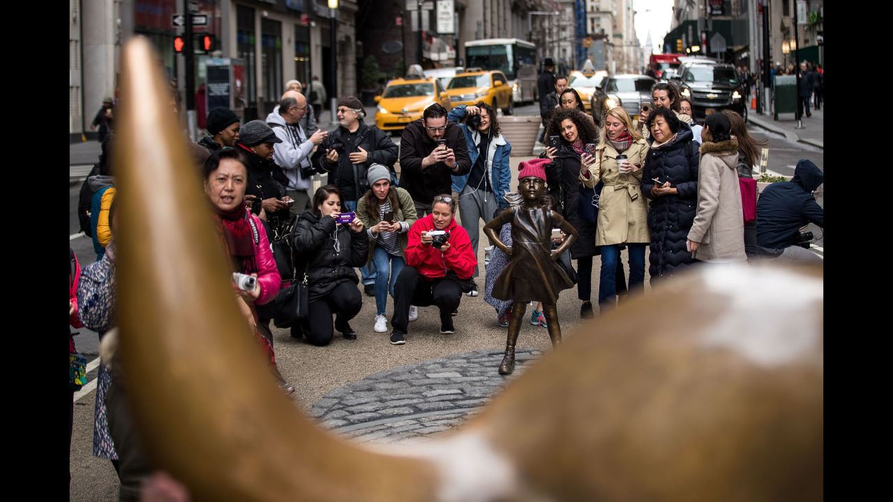 Visitors take photos of the defiant girl, with hands on her hips, chin high and ponytail out, as she stands firm opposite the charging bull. Kristen Visbal, the artist behind "Fearless Girl," says she's been inundated with calls and emails about the work.