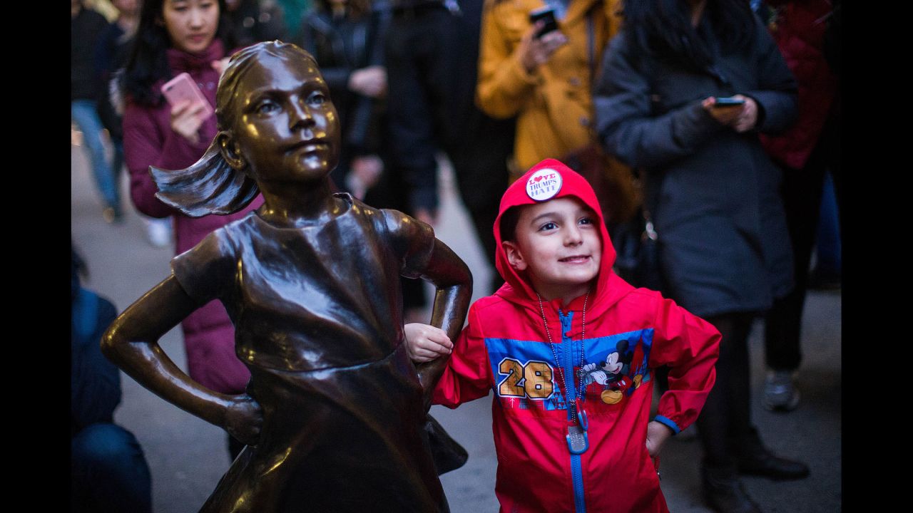 Kenny Simmers, 4, of New Jersey strikes a pose with the "Fearless Girl."