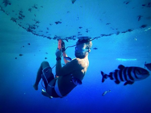 While at sea Bertish had to perform essential maintenance on the vessel, including clearing the underside of the board -- all the while watching out for sharks.