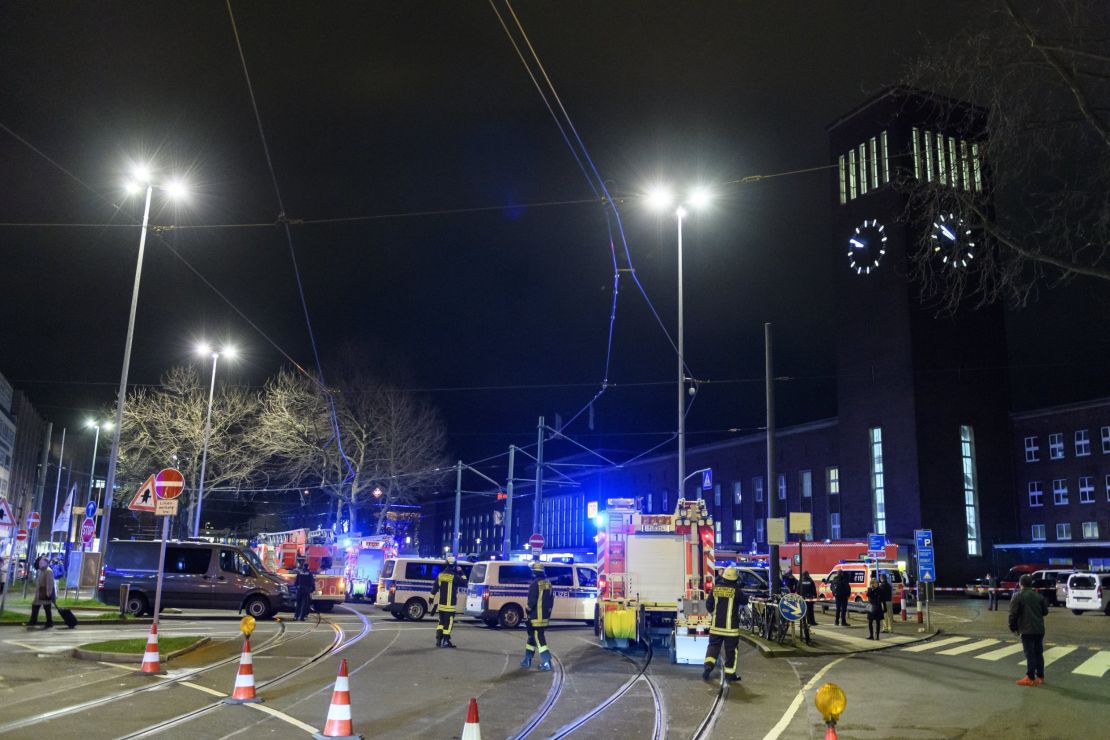 Police and emergency workers stand outside the main railway station Thursday following what police described as an ax attack in Dusseldorf, Germany.