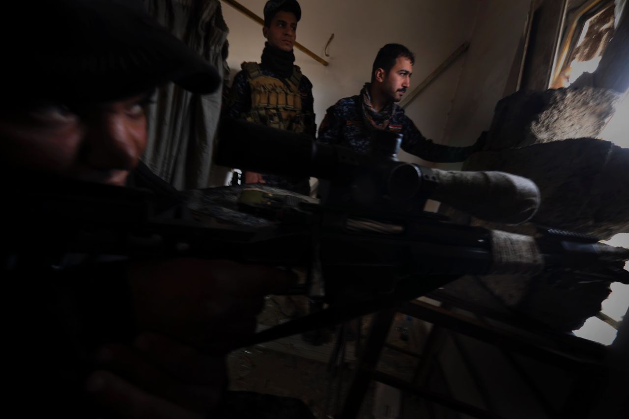 An Iraqi Federal Police sniper fires at ISIS positions in Mosul city.