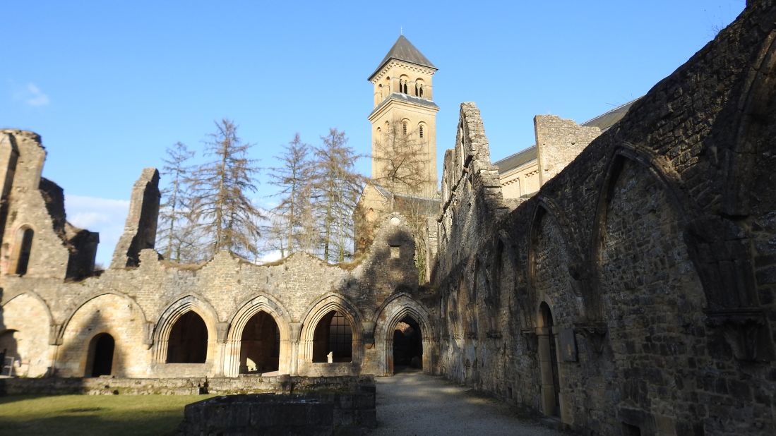 The cloisters of the old abbey can still be seen today. The newer 20th-century reconstruction towers above.