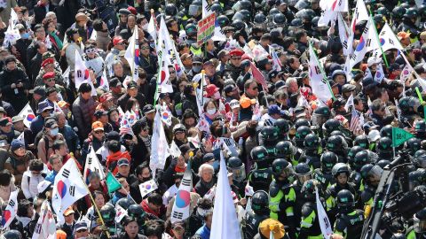 Supporters of South Korean President Park Geun-hye are blocked by police officers as they march toward the Constitutional Court.