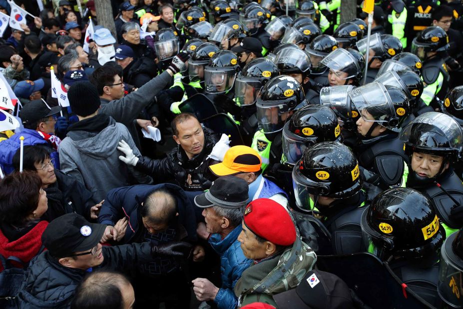 Park supporters are blocked by police during their march toward the Constitutional Court.