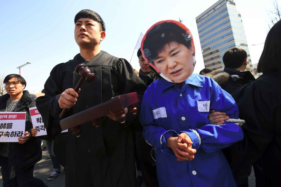 An anti-government activist wears a Park mask.