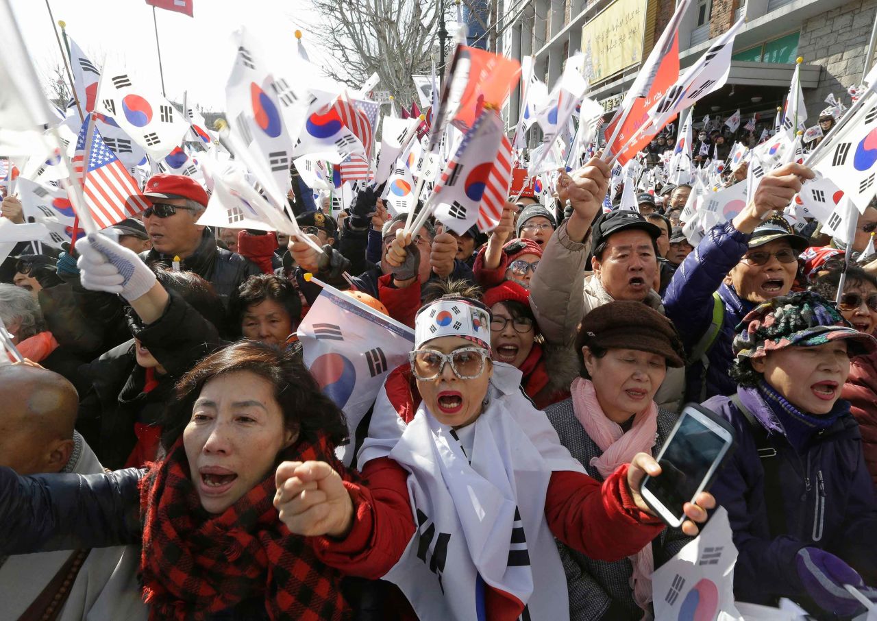 Park supporters shout slogans and wave South Korean flags during a rally to oppose her impeachment.