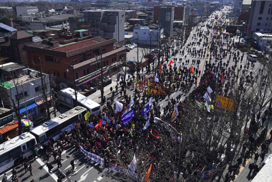 Anti-government activists march toward the presidential palace, known as the Blue House. Park will not leave the Blue House immediately, a spokesman told CNN. 