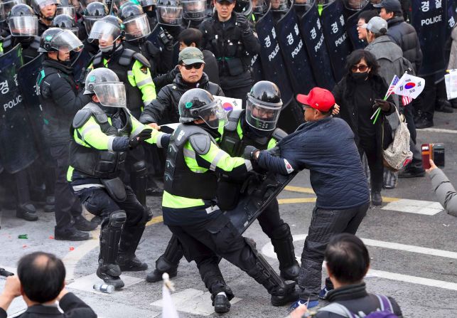 Park supporters clash with police after the country's Constitutional Court announced it would uphold her impeachment.