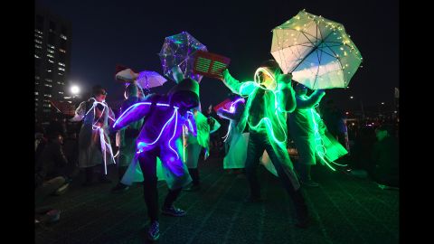 Demonstrators wearing illuminated costumes take part in a rally demanding Park's arrest. Now stripped of her immunity, Park is vulnerable to prosecution in the scandal that triggered her removal. Lawmakers and judges agreed that she abused her authority in helping a friend raise donations from companies.