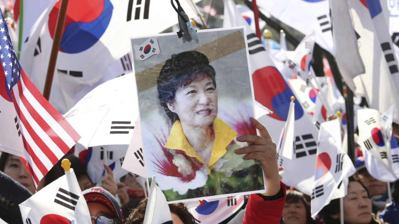A supporter holds a portrait of Park during a rally opposing her impeachment.