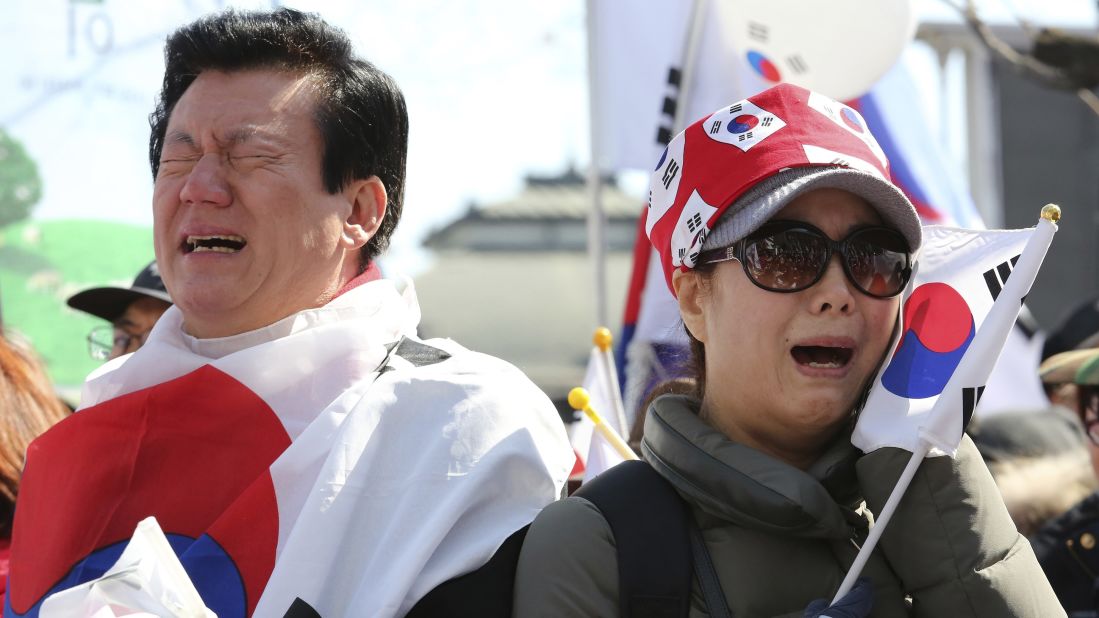 People opposing Park's impeachment cry during a rally near the Constitutional Court.