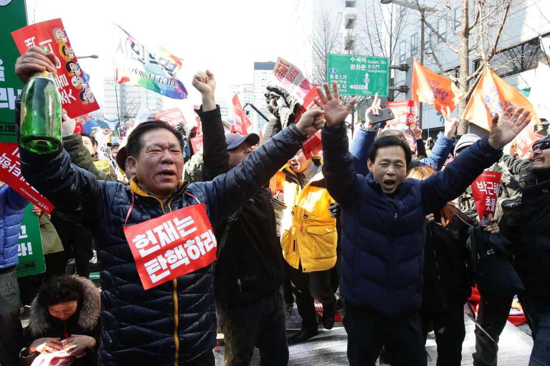 South Koreans celebrate after hearing the Constitutional Court's verdict.
