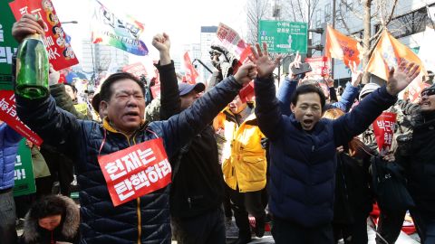 South Koreans celebrate after hearing the Constitutional Court's verdict.