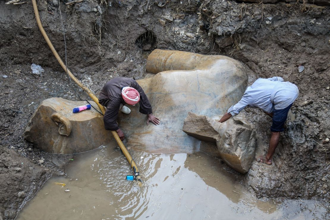 Achaeologists drain the groundwater seeping in to the dig in Matariya, Cairo.