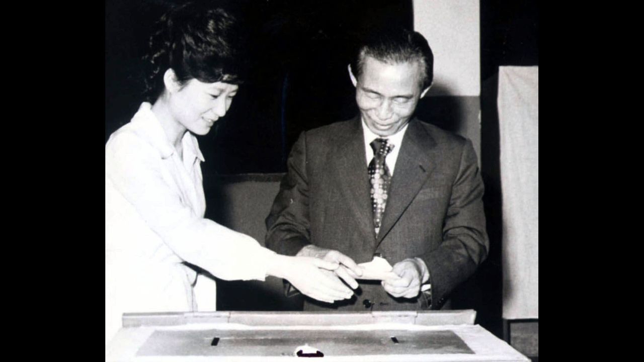 Park casts a ballot with her father, who was assassinated by his own security chief in 1979. After the loss of her father, Park withdrew from the public sphere, living what she described as "a very normal life."