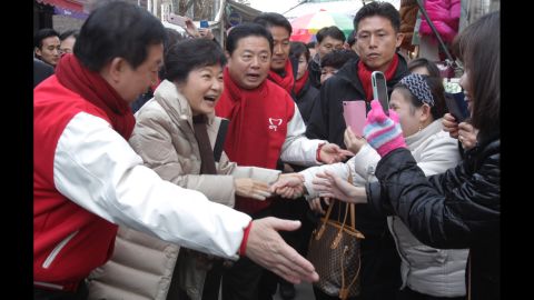 Park greets people in downtown Seoul during the launch of her presidential campaign in November 2012.