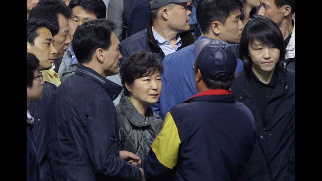 Park talks with families of missing passengers after the Sewol ferry disaster in April 2014. The passenger ferry sank a day earlier, killing 304 people. Most of those aboard were high school students on a field trip to Jeju island, off South Korea's southern coast.