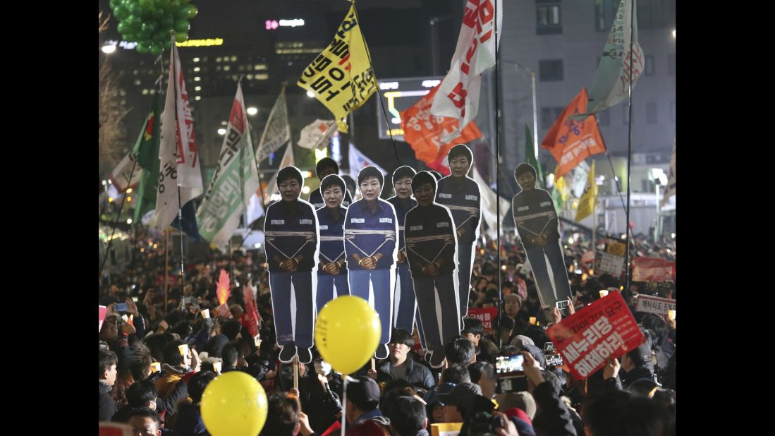 After the corruption allegations surfaced, demonstrators carry cutouts of Park during a December 2016 rally calling for her to step down.