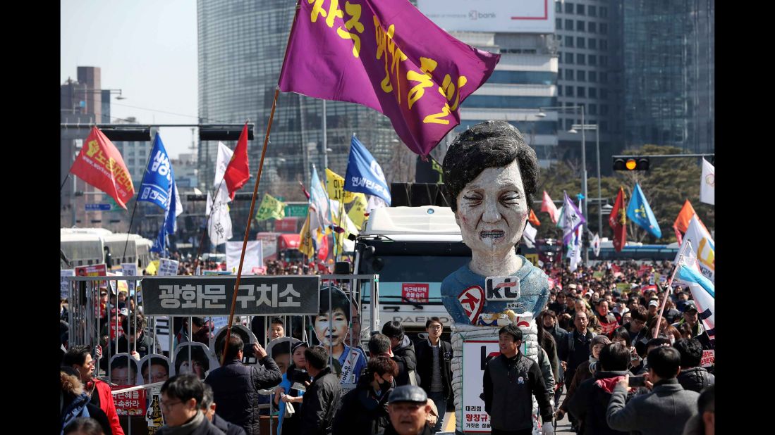 Anti-Park protesters carry an effigy of the ousted president as they march toward the Blue House in March. Stripped of her immunity, Park is now liable to prosecution and must vacate the Blue House.