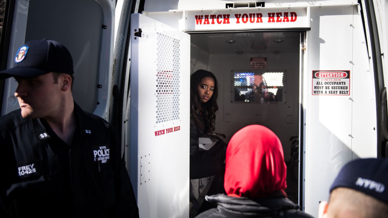 Activist Tamika Mallory, one of the founders of the Women's March movement, sits in the back of a police van Wednesday, March 8, after being detained for blocking traffic outside the Trump International Hotel and Tower in New York. Thirteen women outside the hotel <a href="http://www.cnn.com/2017/03/08/politics/womens-march-organizers-detained/" target="_blank">were arrested for disorderly conduct</a> during the "Day Without a Woman" march, a spokesman for the New York Police Department said. <a href="https://twitter.com/womensmarch/status/839558787753263104" target="_blank" target="_blank">The Women's March tweeted:</a> "Many of our national organizers have been arrested in an act of civil disobedience. We will not be silent."