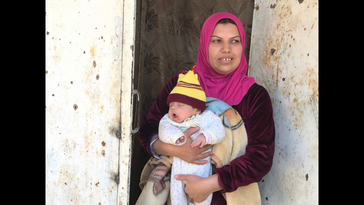 Um Mohammed, one of the few civilians remaining in western Mosul as fighting rages, stands in front of her house holding her month-old son. She told CNN that her family hid with several others in the basement of her house for 16 days while the battle raged. They lived on cold porridge because there was no running water or electricity in the city. Um Mohammed said she had to give the children sleeping medicine so ISIS wouldn't hear them.