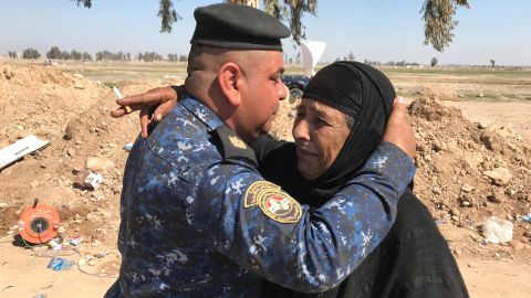 An Iraqi Federal Police officer hugs and kisses the forehead of a woman named Mariam who fled with her family from the Mahata neighborhood early in the morning. Mariam told CNN that ISIS forbade her to smoke, yet their fighters drank alcohol, smoked and took pills. She said anyone caught smoking under ISIS rule was punished, sometimes by having their tongues or fingers cut off.