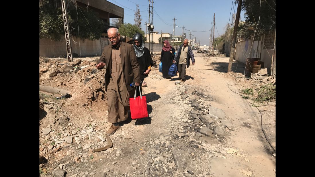 A family from western Mosul flees on foot with the few belongings they were able to carry with them. More than 57,000 people have been displaced since Iraqi forces moved to retake the western part of the city last month, according to the United Nations.