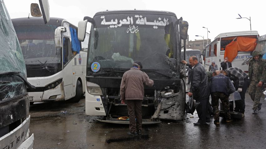 Syrian security forces, forensics and locals gather at the scene of a bombing following twin attacks targeting Shiite pilgrims in Damascus' Old City on March 11, 2017. A roadside bomb detonated as a bus passed and a suicide bomber blew himself up in the Bab al-Saghir area, which houses several Shiite mausoleums that draw pilgrims from around the world, the Syrian Observatory for Human Rights said.