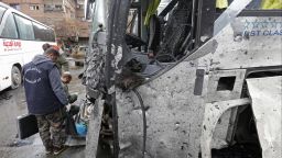 Syrian forensics examine a bus at the scene of a bombing following twin attacks targeting Shiite pilgrims in Damascus' Old City on March 11, 2017. A roadside bomb detonated as a bus passed and a suicide bomber blew himself up in the Bab al-Saghir area, which houses several Shiite mausoleums that draw pilgrims from around the world, the Syrian Observatory for Human Rights said. 